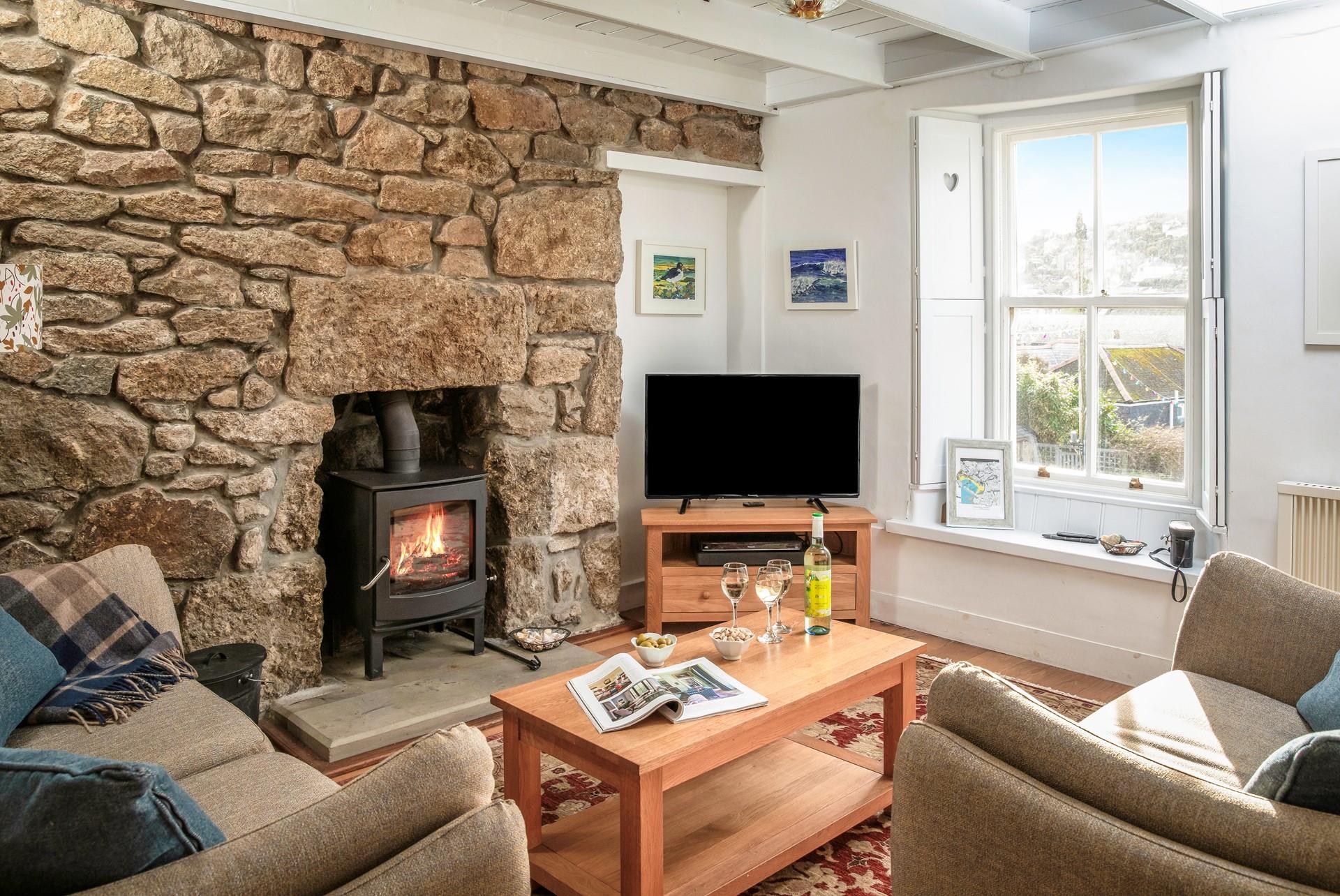 Cosy up in front of the woodburner in the sitting room.