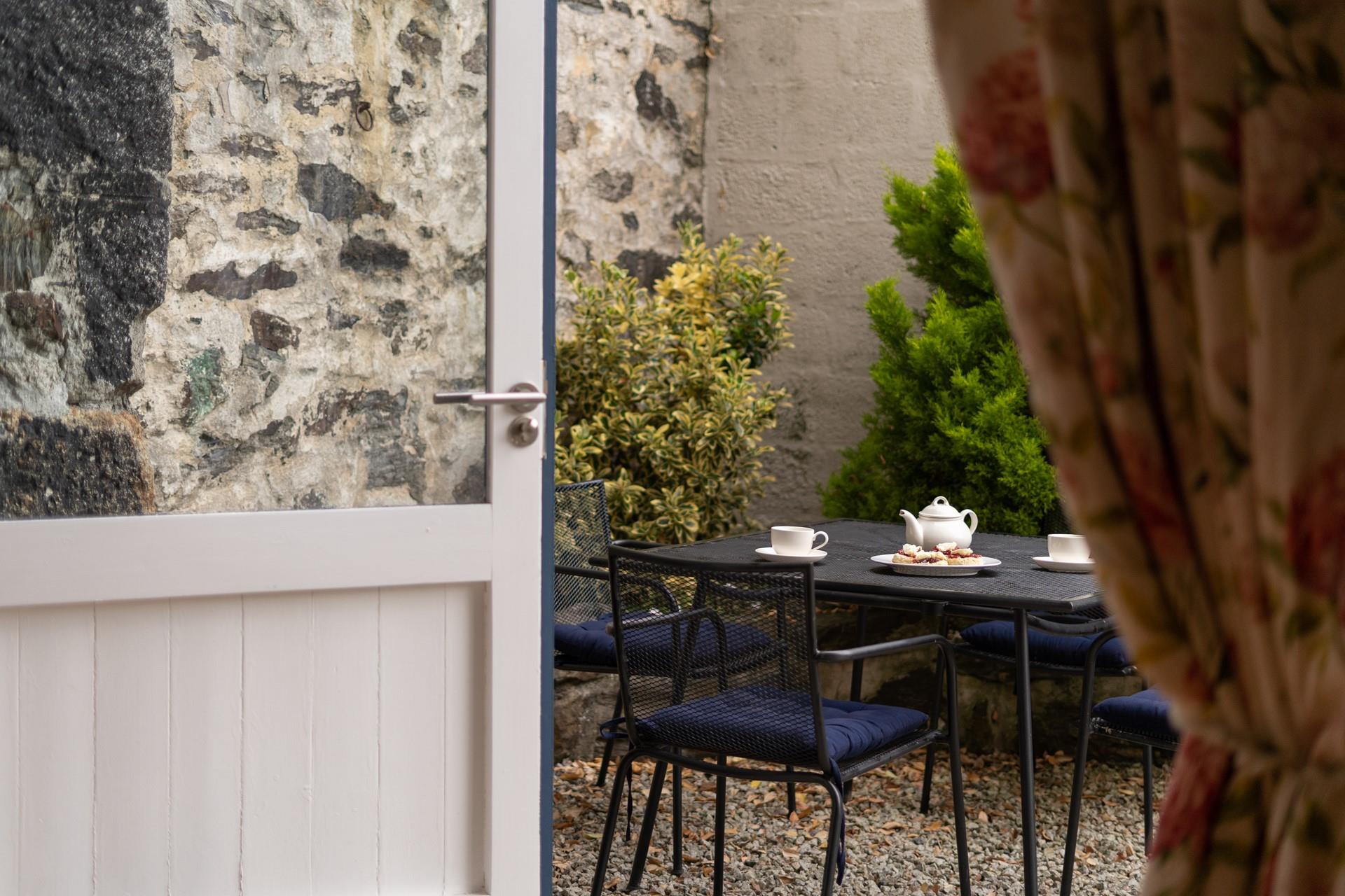 Open the doors and step out into the tranquil courtyard, the perfect space to relax and unwind alone or with company.