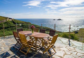 Lounge in the Cornish sun on Cove Cottage's ocean-facing patio.