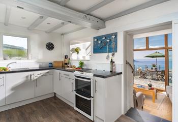 Take in the sea views as the kitchen steps down into the sun room.