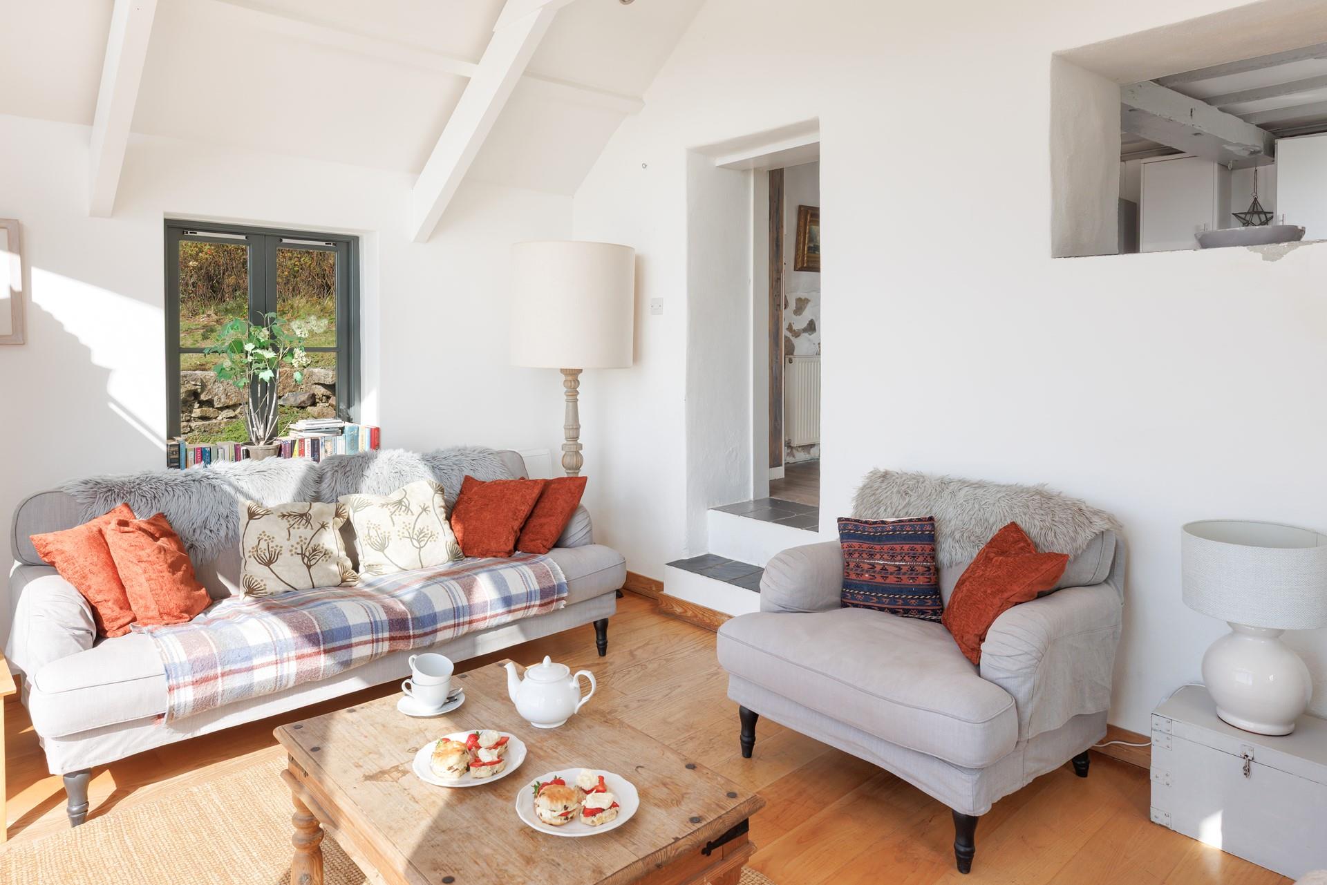 Cool tones and subtle shades mimic the ever-changing skies in Cove Cottage's sunroom.