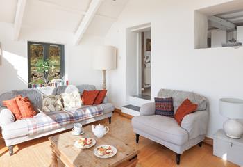 Cool tones and subtle shades mimic the ever-changing skies in Cove Cottage's sunroom.