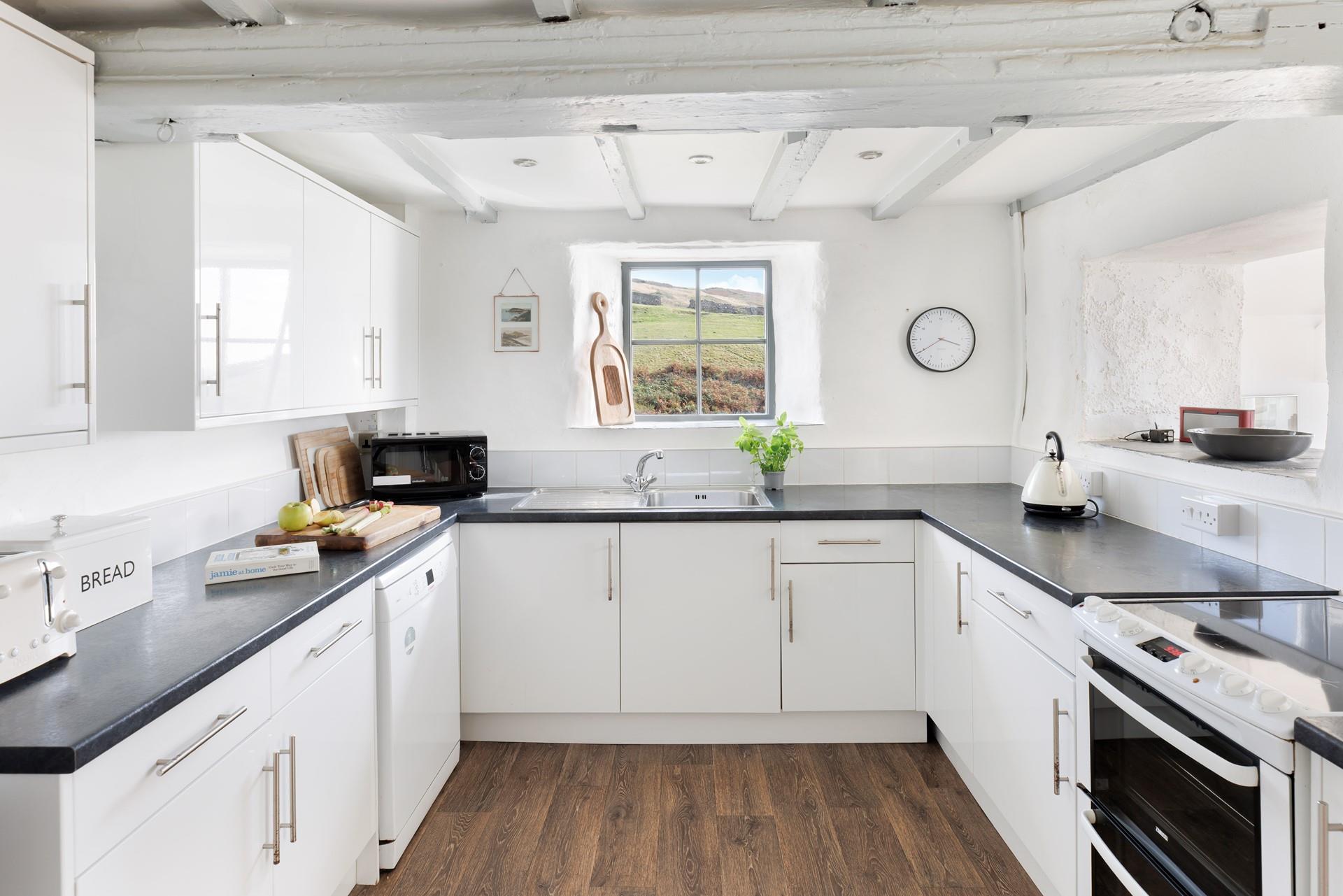Take in the sea views as the kitchen steps down into the sun room.
