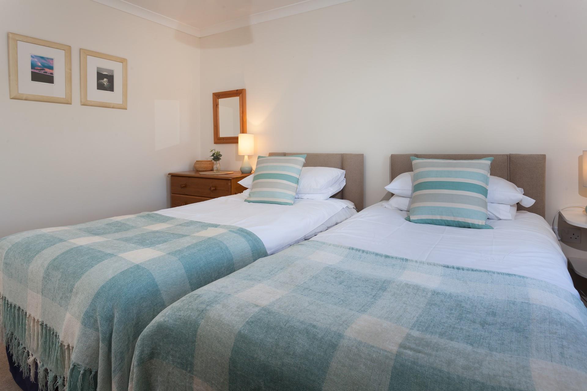 Plump pillows and soft white linen promise a restful night's sleep.