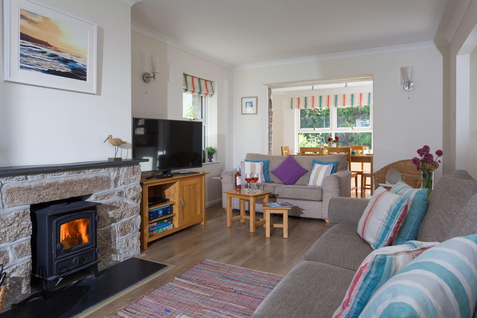 The log burner creates a cosy atmosphere in the sitting room. 