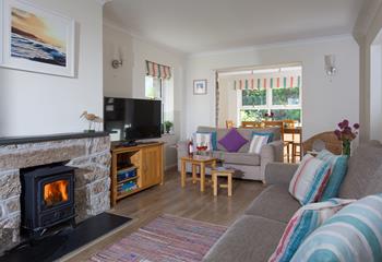 The log burner creates a cosy atmosphere in the sitting room. 