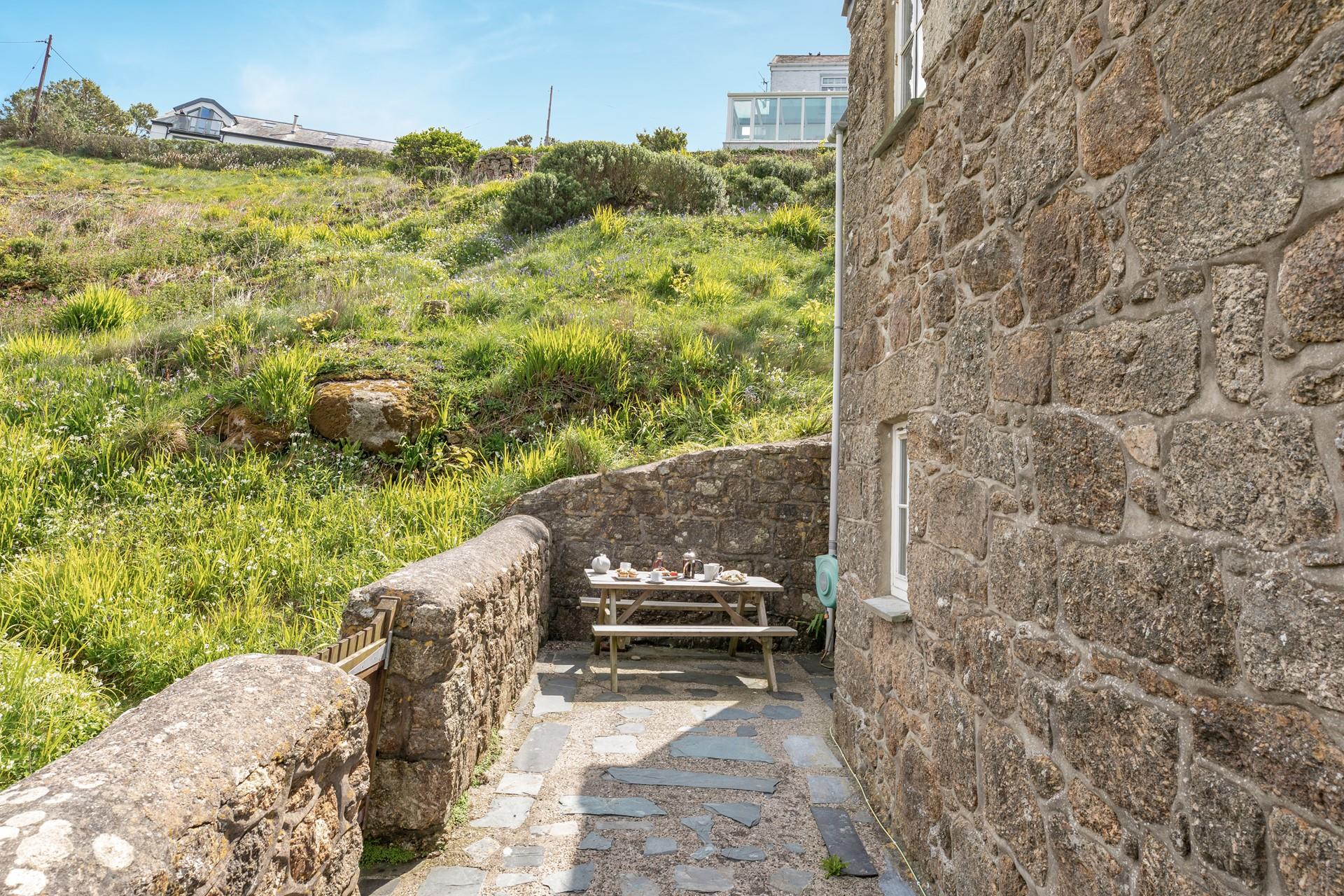 Patios on either side of the cottage means you can enjoy the morning and evening sun!