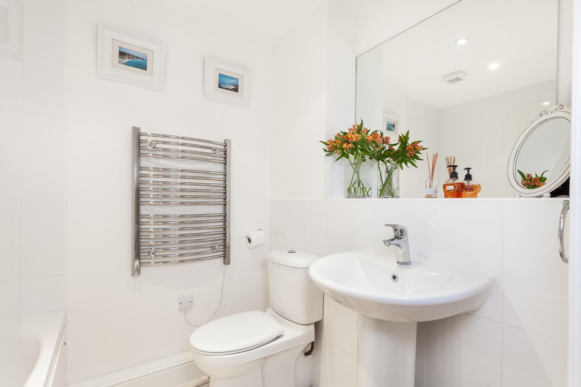 Relax in a bubble bath after a day on the beach in the family bathroom. 