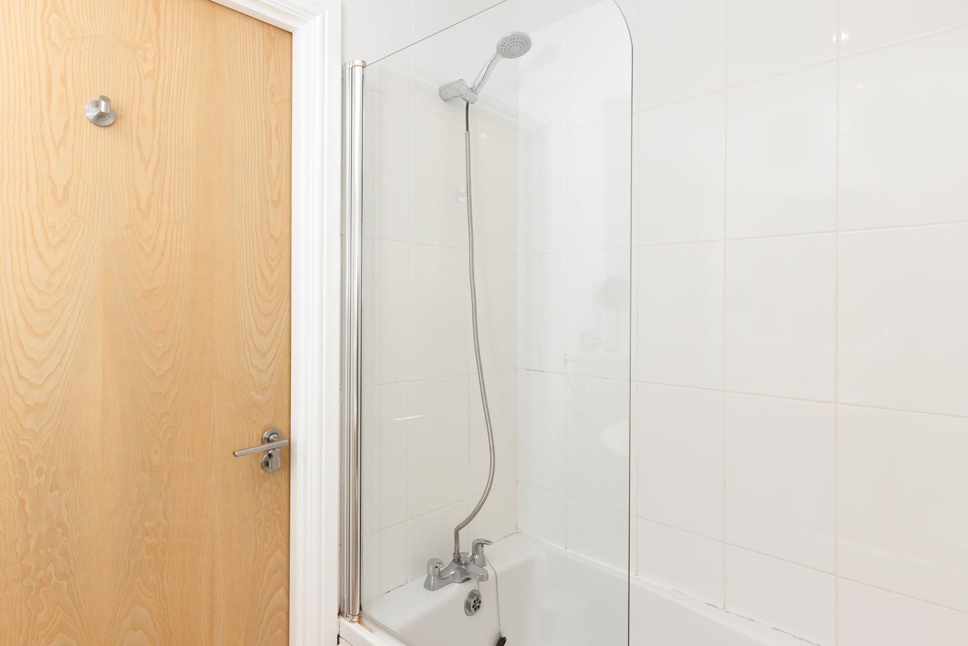 Relax in a bubble bath after a day on the beach in the family bathroom. 