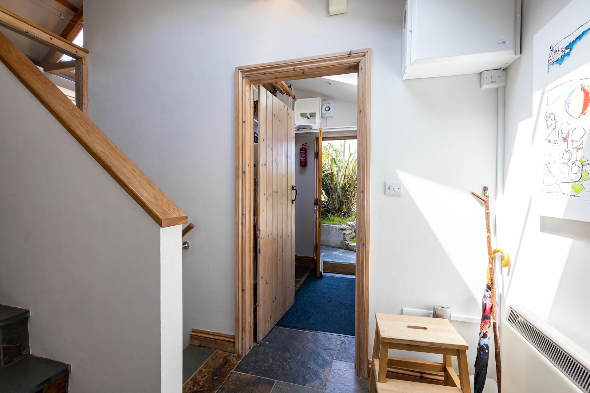 The cloakroom is a handy space featuring a washing machine and tumble dryer.