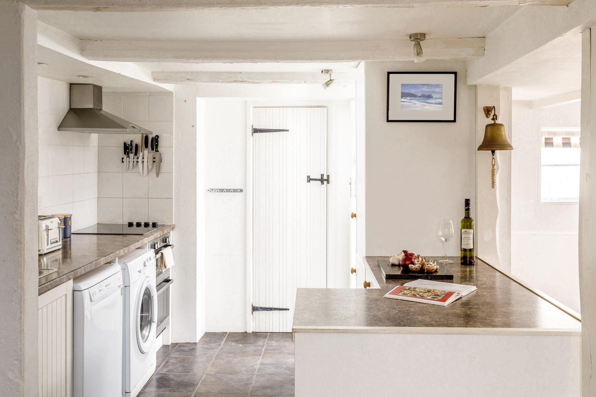 A bright open plan kitchen for the family with hint of blue and seaside features. 