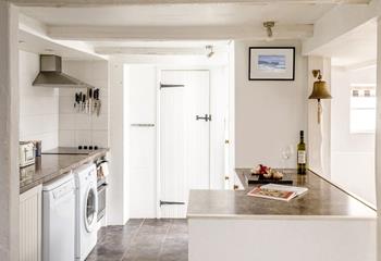 A bright open plan kitchen for the family with hint of blue and seaside features. 