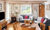 The open plan sitting/dining/kitchen area is traditionally furnished for a cosy and relaxing atmosphere.  - Thumbnail Image