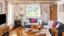 The open plan sitting/dining/kitchen area is traditionally furnished for a cosy and relaxing atmosphere. 