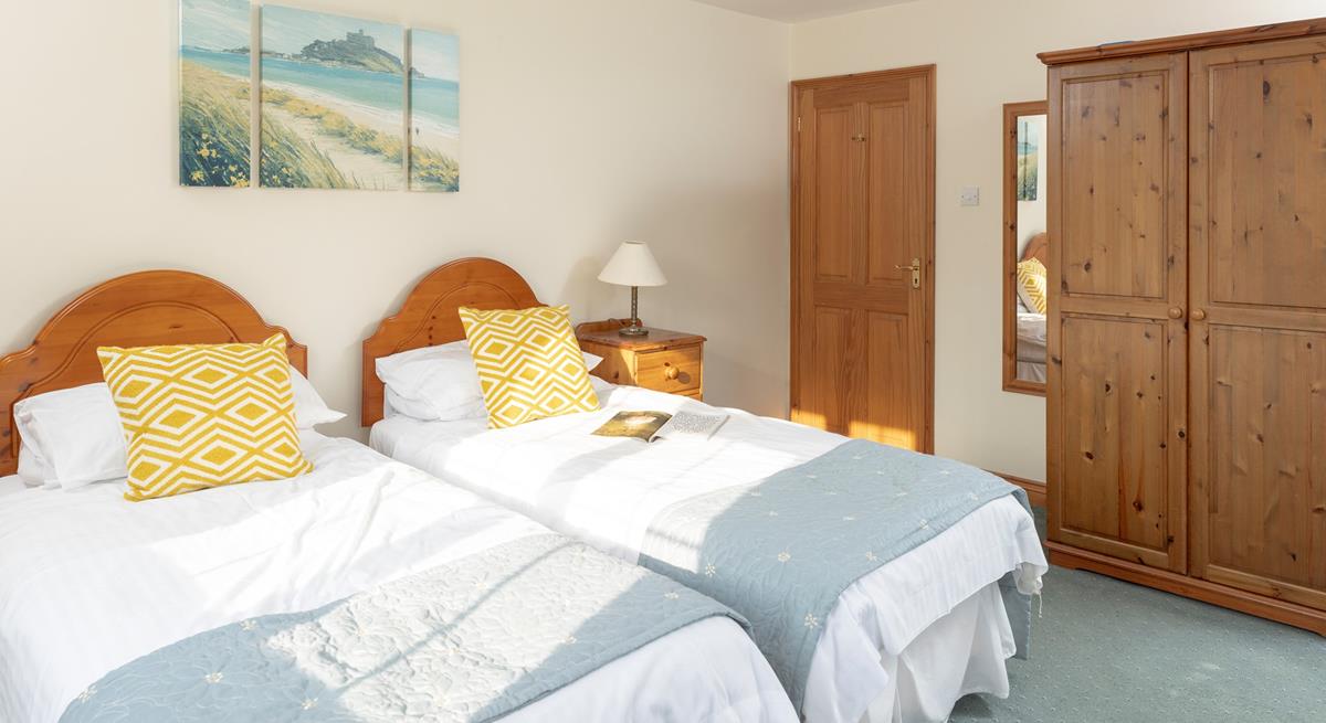 Calming coastal colours decorate the second bedroom.