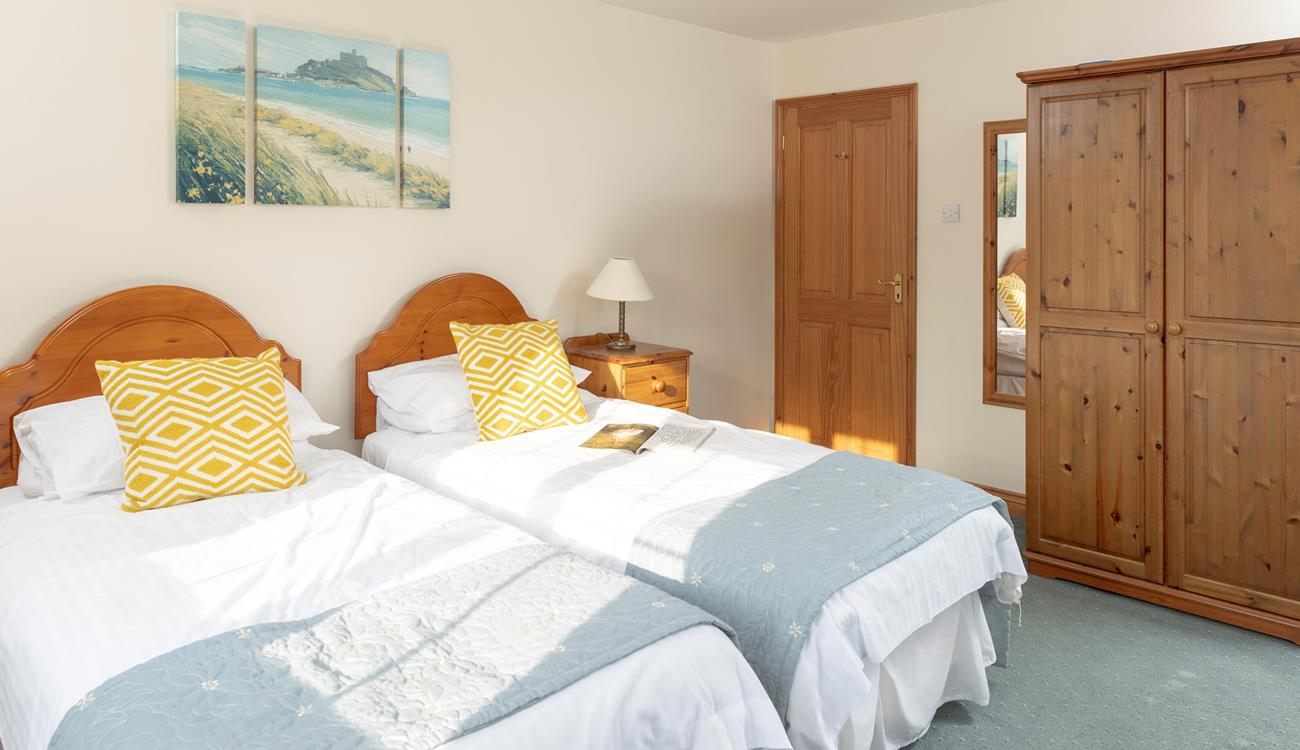 Calming coastal colours decorate the second bedroom.