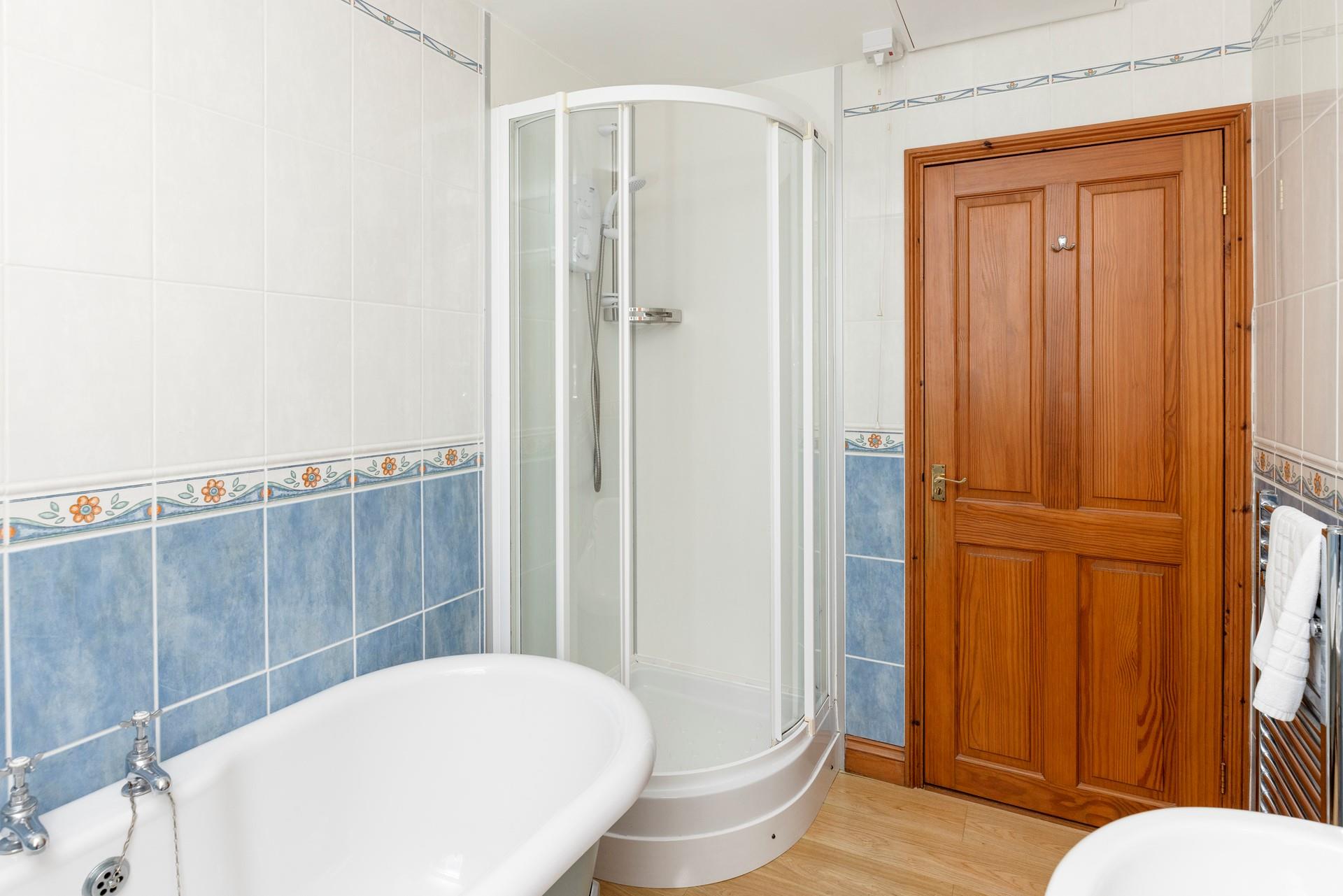 The family bathroom benefits from a separate shower cubicle.