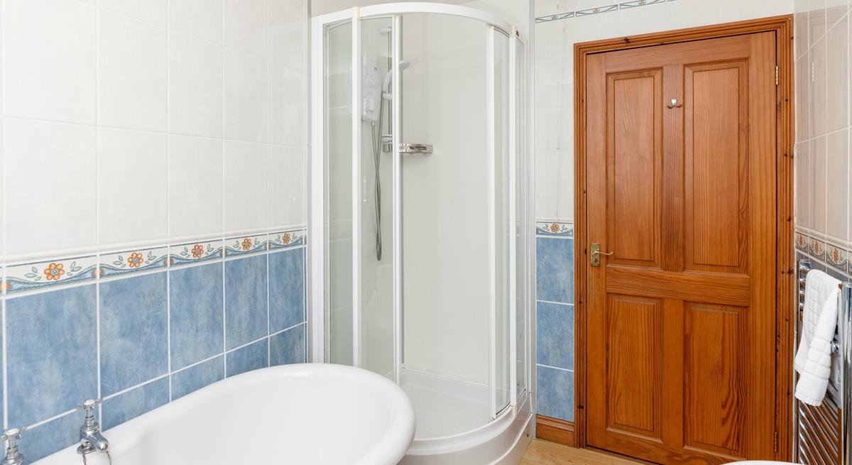 The family bathroom benefits from a separate shower cubicle.