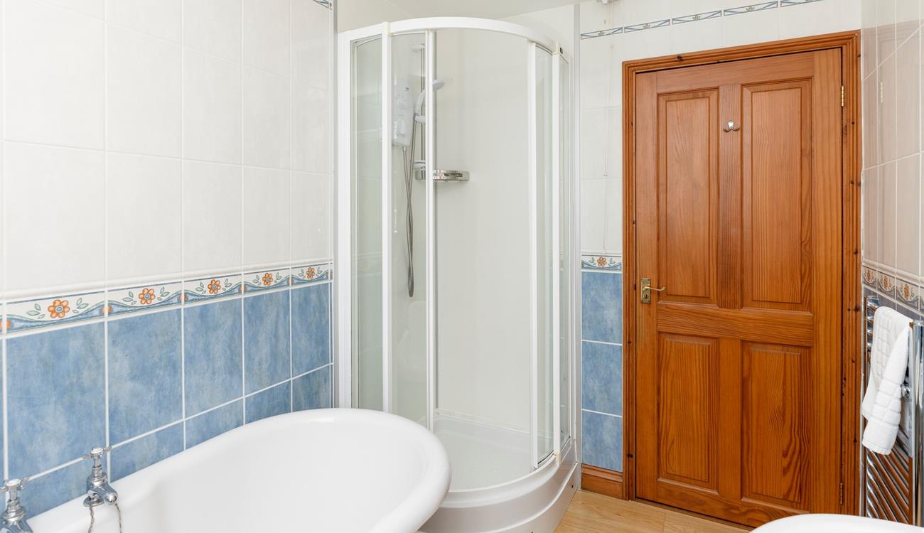 The family bathroom benefits from a separate shower cubicle.