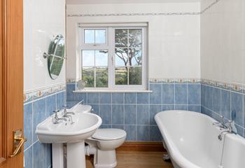 The bathroom has a luxurious roll-top bath and lovely country views.