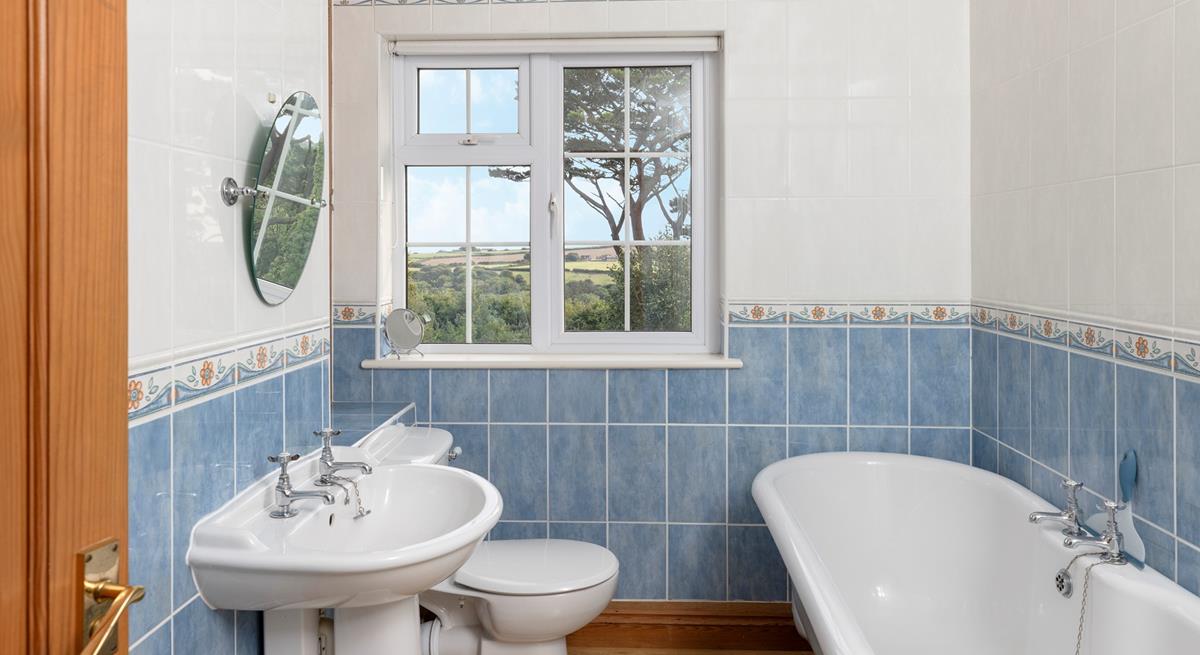 The bathroom has a luxurious roll-top bath and lovely country views.