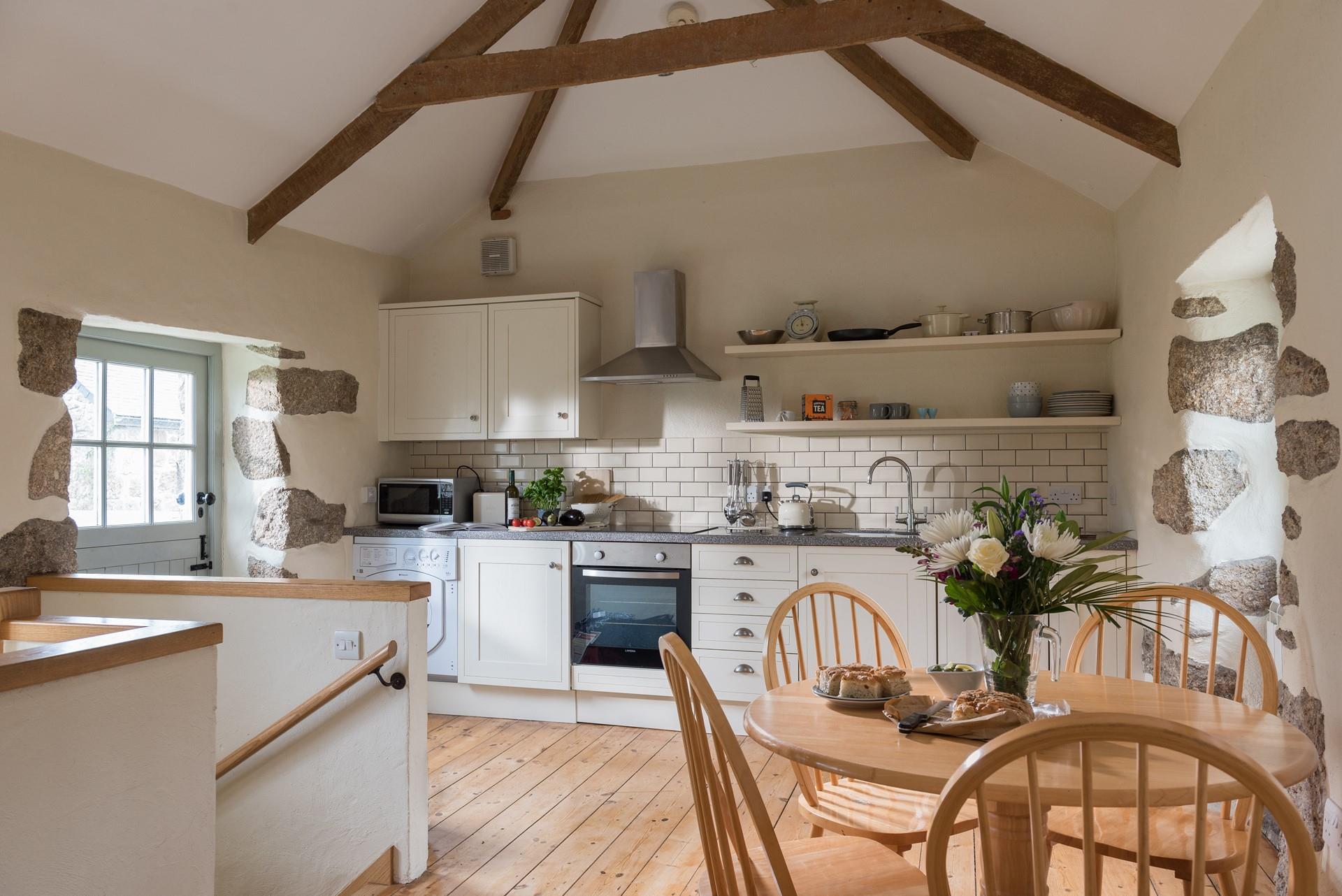 Stairs lead down from the kitchen/dining/sitting room to the ground floor bedroom. 