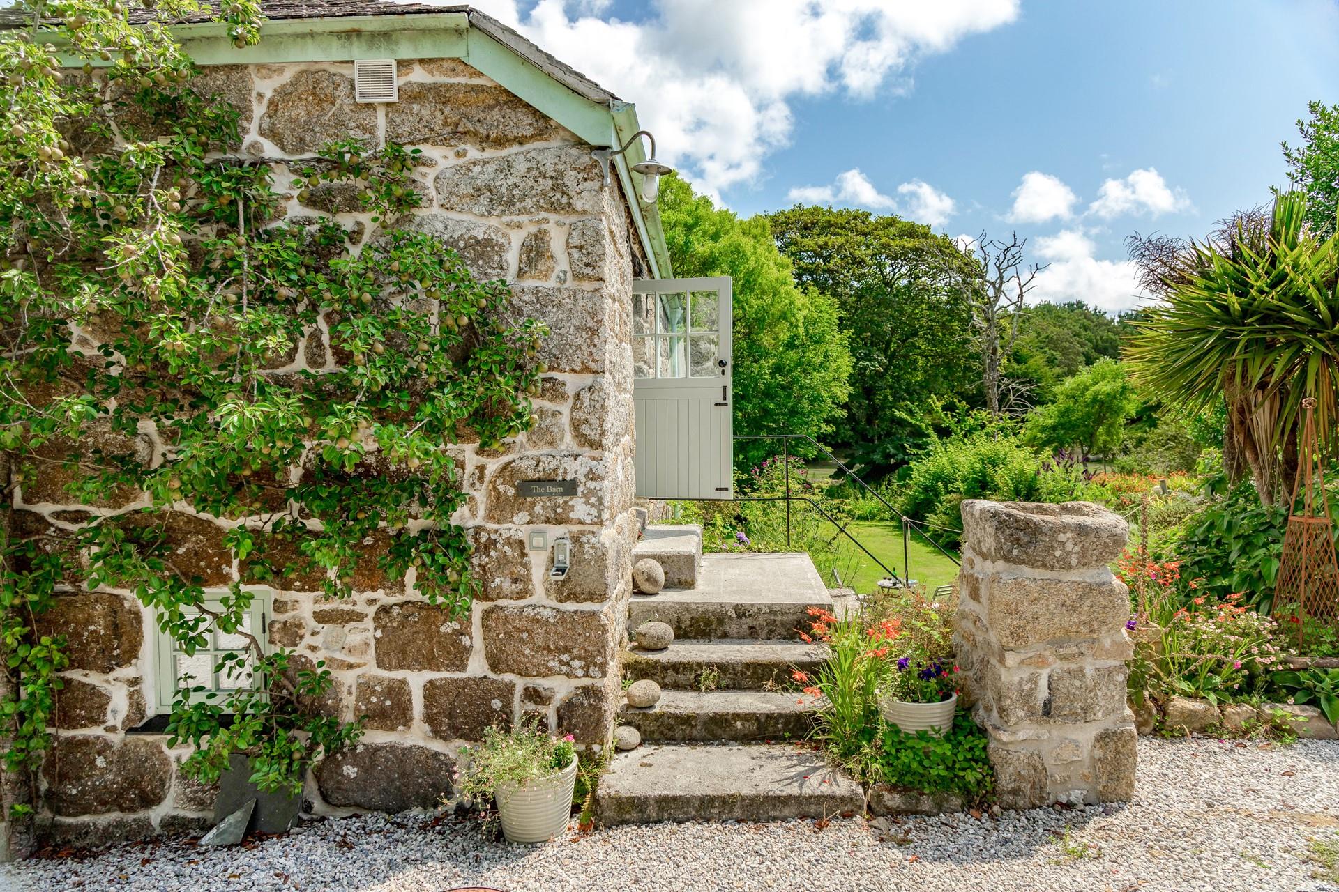 Stone steps lead up to the entrance stable door. 