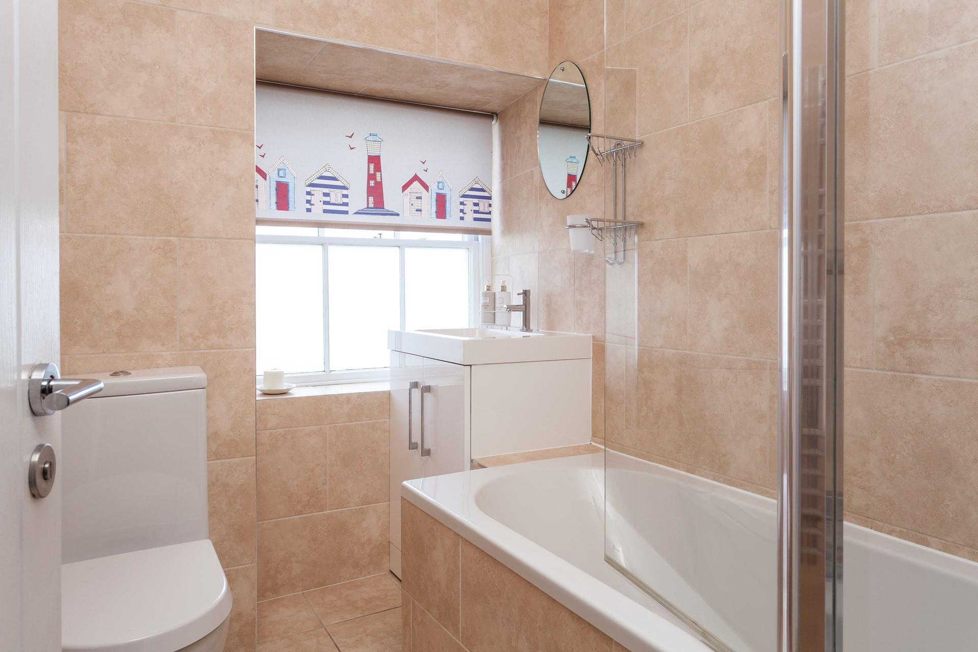 The modern bathroom has a bath and shower.
