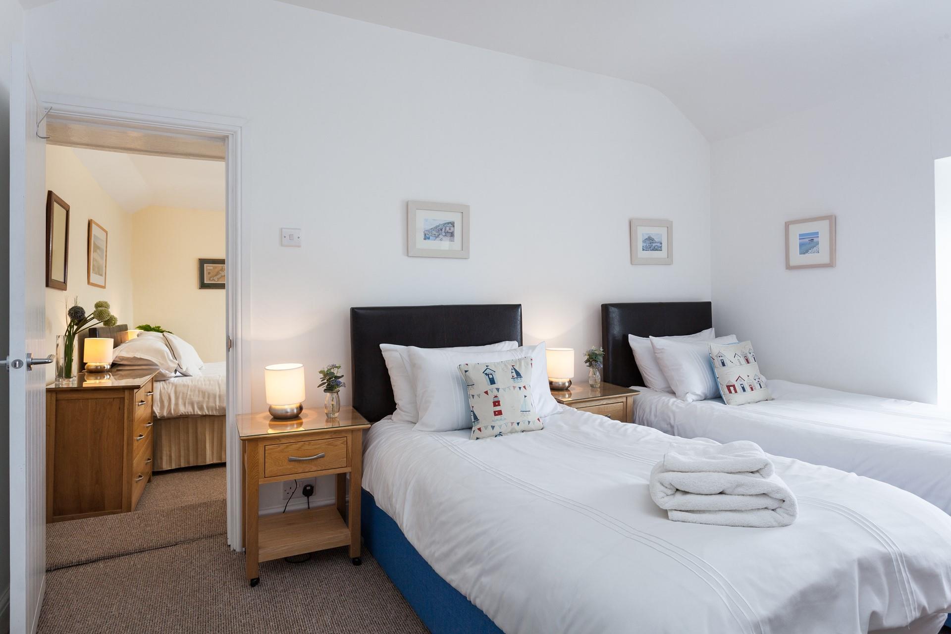 Bedroom 2 has twin beds and leads into bedroom 3.