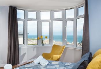 Wake up and take in the wonderful views from this superbly sized and colourful bedroom.
