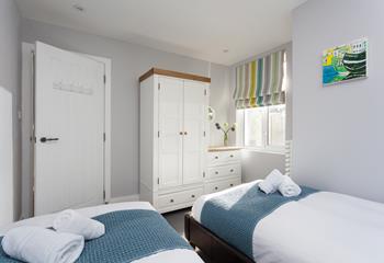 There is plenty of storage in this bright airy bedroom.