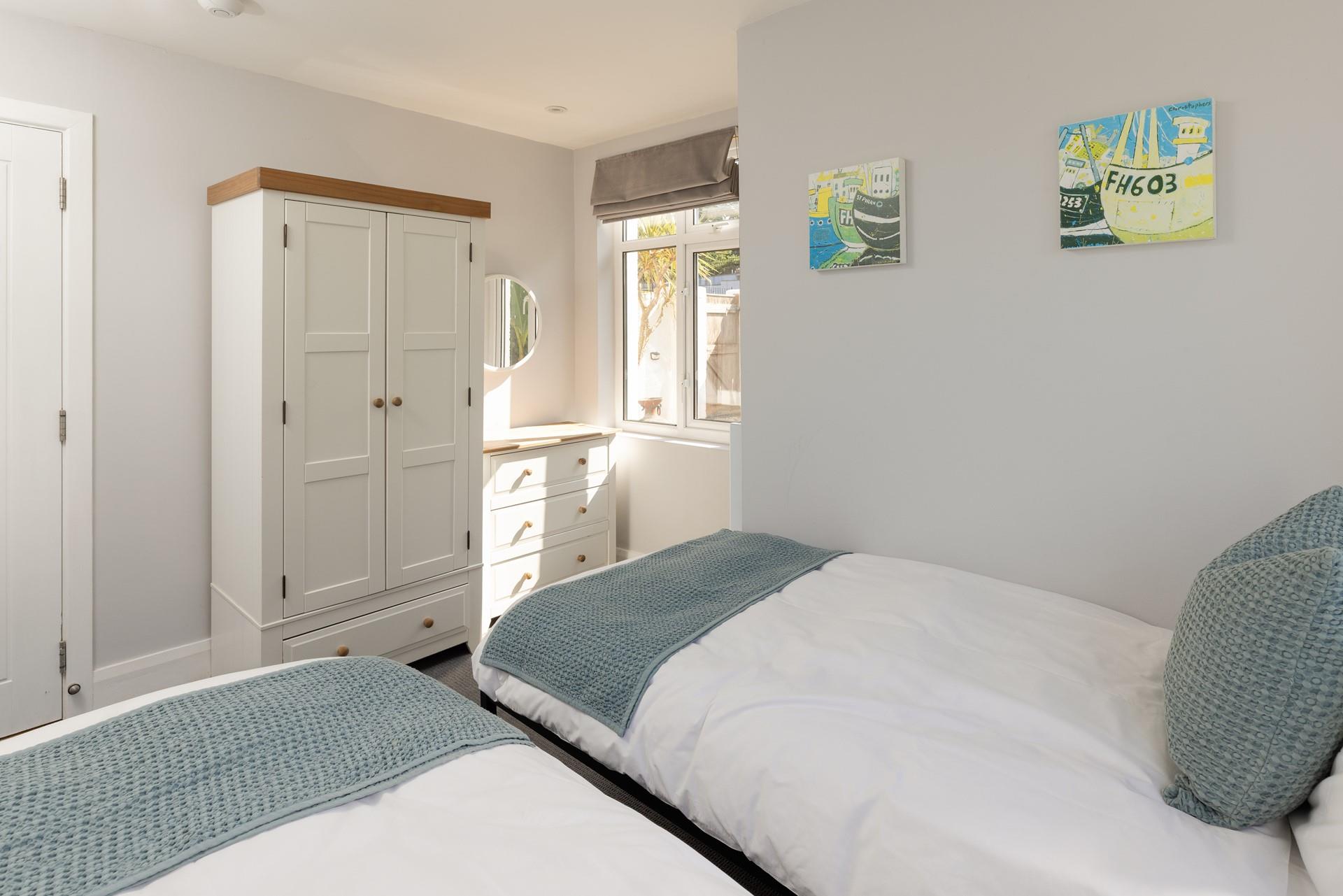 There is plenty of storage in this bright, airy bedroom.