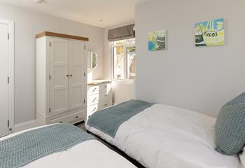There is plenty of storage in this bright, airy bedroom.