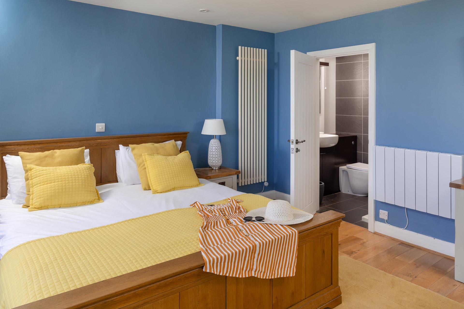 Bedroom 1 boasts a stylish en suite with a walk-in shower.