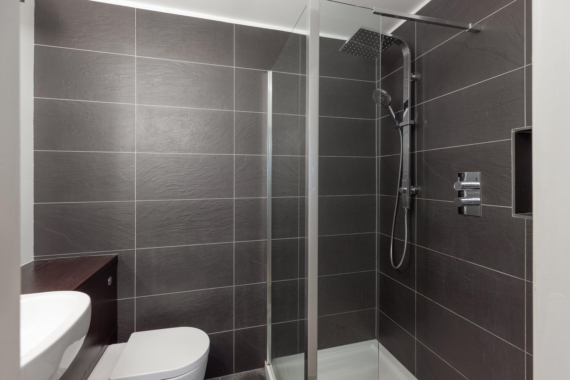 Step into the luxurious rainfall shower for a refreshing start to the day.