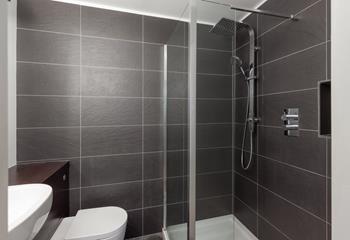 Step into the luxurious rainfall shower for a refreshing start to the day.