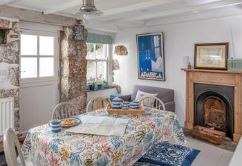 A feature fireplace and exposed stone walls add to the charm and history of this house. 