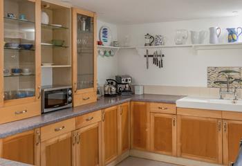 The kitchen is spacious with everything needed to prepare and cook meals.