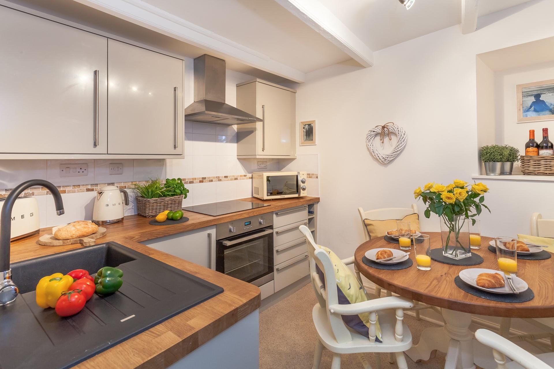 The modern spacious kitchen also has a lovely dining table to spend time as a family over meal times.