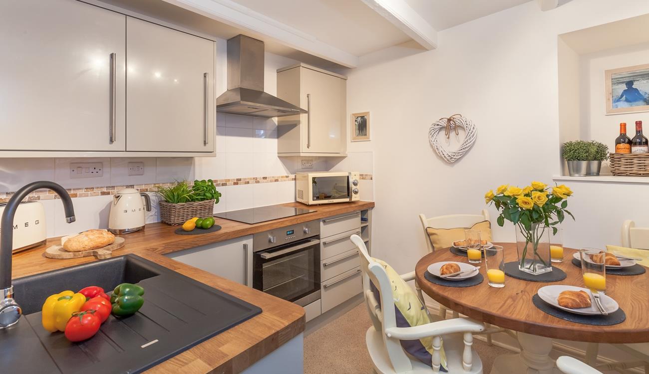 The modern spacious kitchen also has a lovely dining table to spend time as a family over meal times.