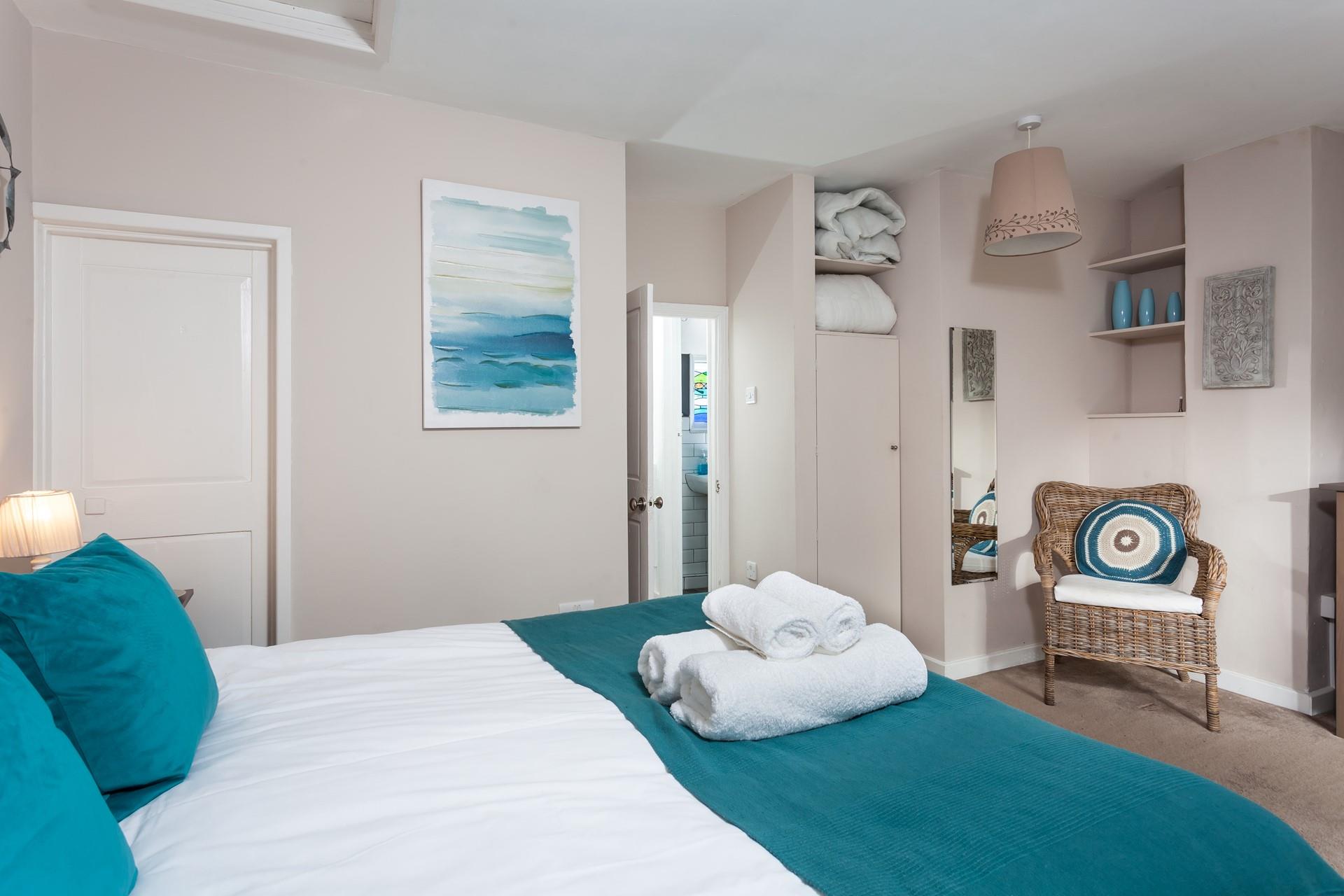 The bedroom features various shades of blues reflecting the sea being on your doorstep.