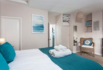 The bedroom features various shades of blues reflecting the sea being on your doorstep.