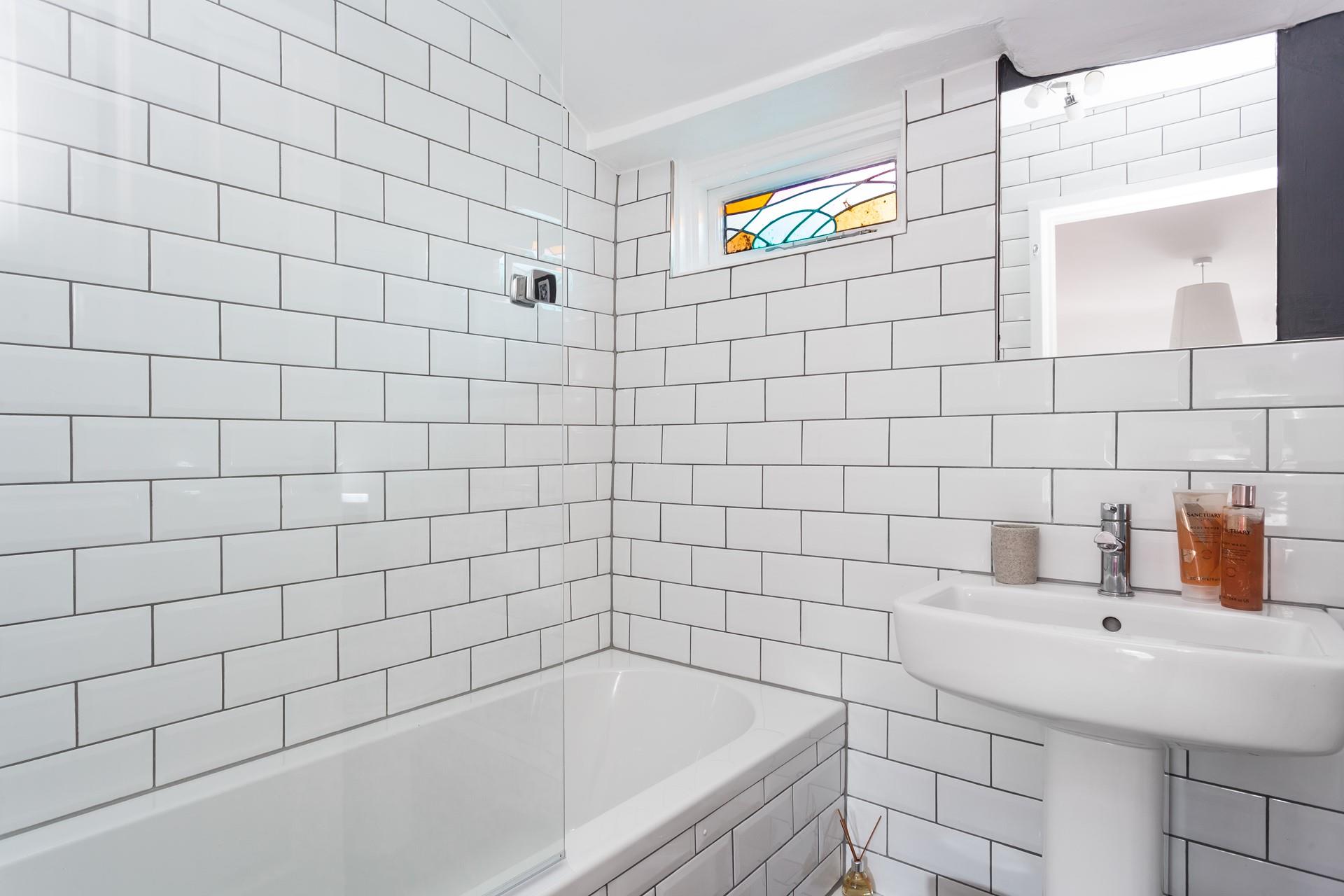 The en suite bathroom is modern and sleek.