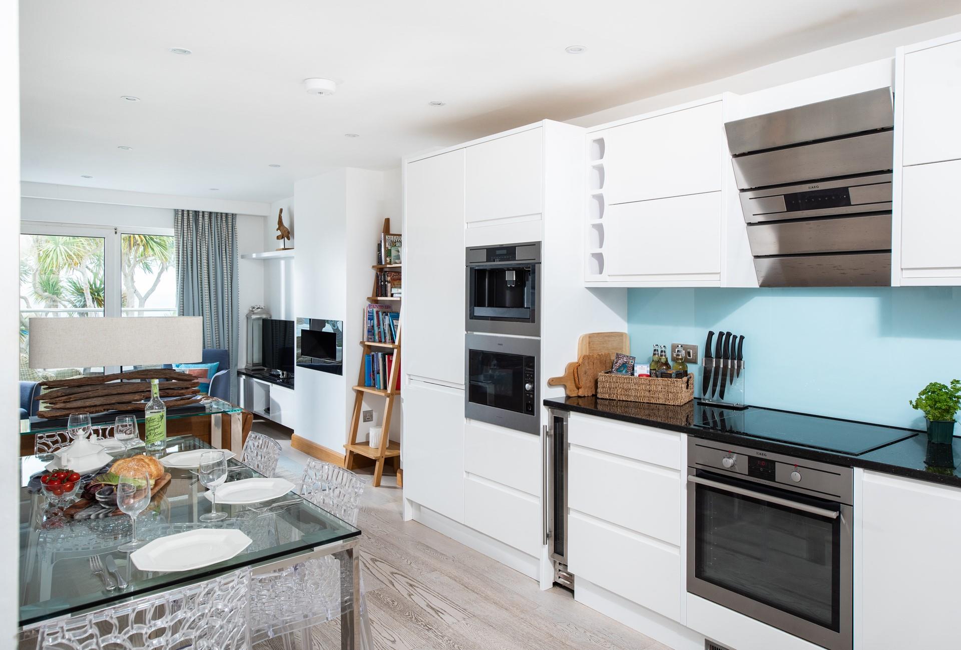 The kitchen is sleek and modern and even has a wine cooler!