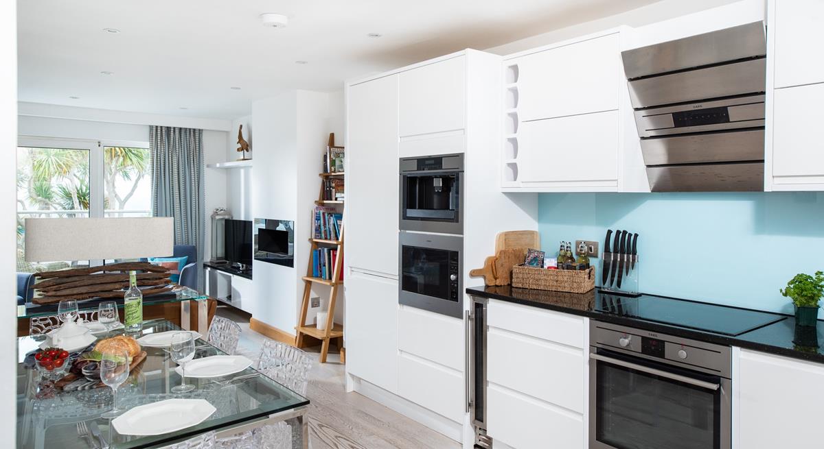 The kitchen is sleek and modern and even has a wine cooler!