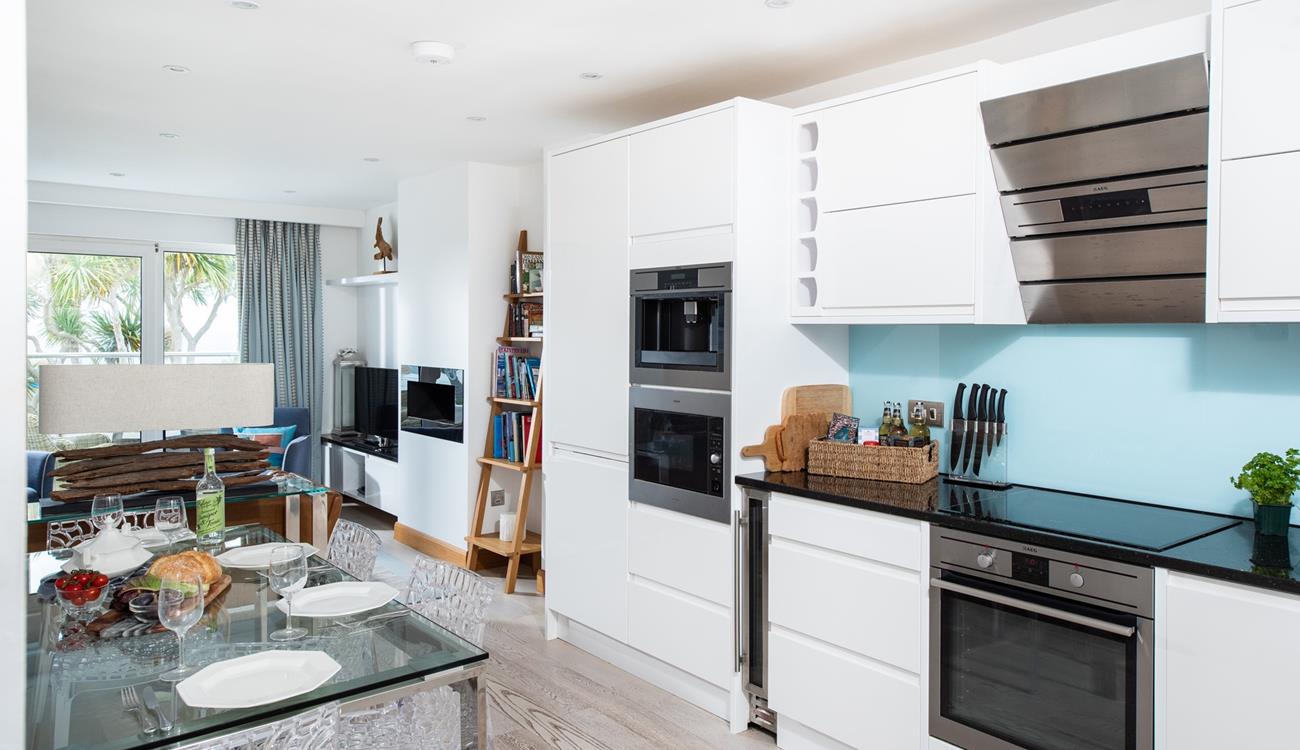 The kitchen is sleek and modern and even has a wine cooler!