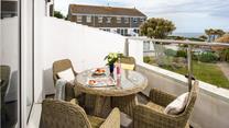The private balcony is perfect for dining al fresco or soaking up the sun with a glass of something chilled in hand.