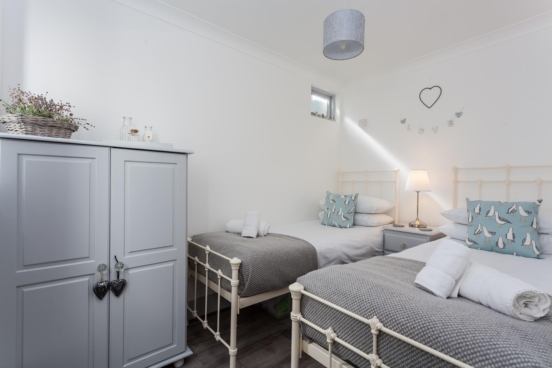 The gorgeous twin room in soft seaside colours is perfect for children.