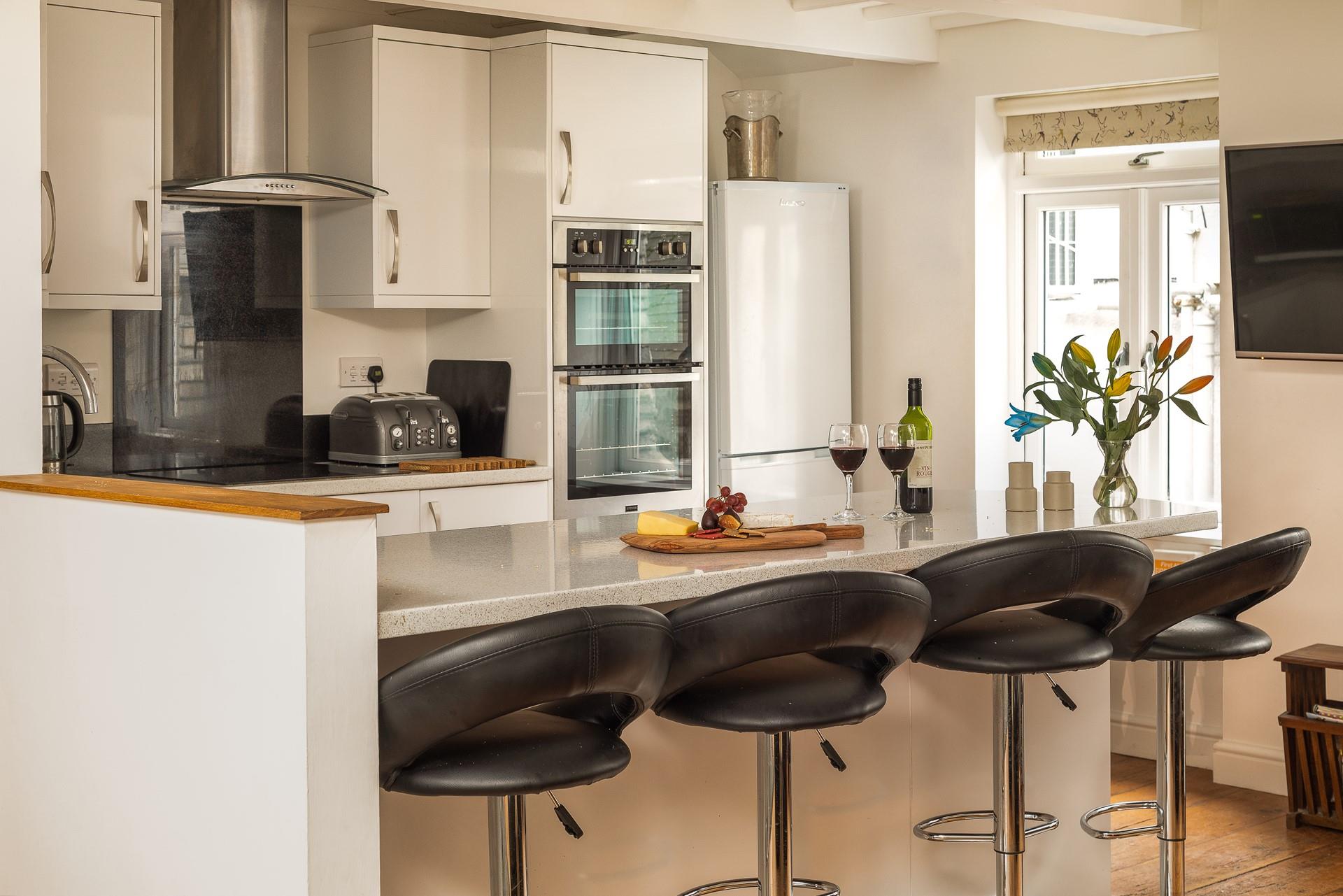 The stylish kitchen is perfectly equipped to rustle up delicious meals.