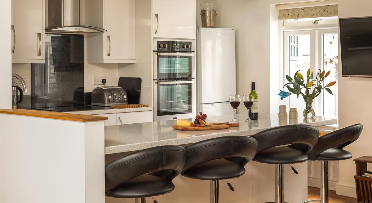 The stylish kitchen is perfectly equipped to rustle up delicious meals.